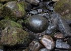 Some gleaming rocks in the spray from the falls.